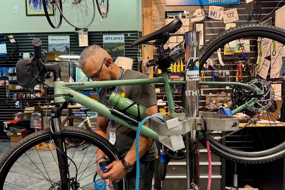 A technician giving expert service to a bike at Sun & Ski Sports.